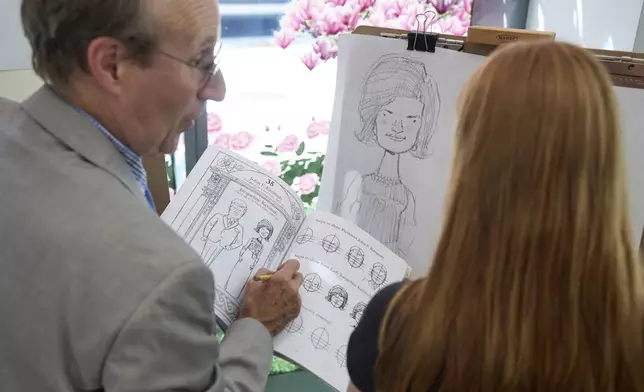 John Hutton, illustrator and professor of art history at Salem College, shows Adelaide Baldus, 16, of La Plata, Md., how to draw a picture of first lady Jacqueline Kennedy, Tuesday, Aug. 12, 2025, from his book, "How To Draw The Presidents and First Ladies," at The People's House, a museum in Washington. (AP Photo/Jacquelyn Martin)