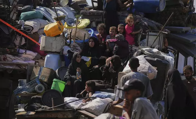 Displaced Palestinians flee Gaza City by foot and vehicles, carrying their belongings along the coastal road toward southern Gaza, Wednesday, Sept. 17, 2025. (AP Photo/Abdel Kareem Hana)