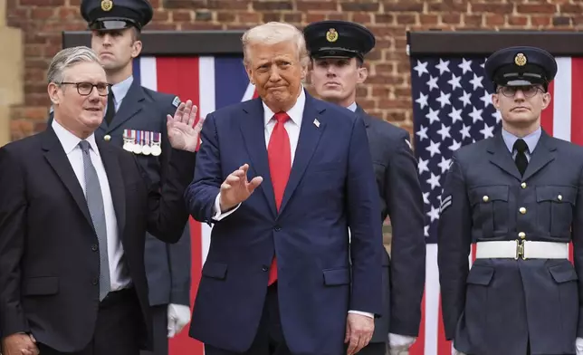President Donald Trump waves next to Britain's Prime Minister Keir Starmer upon arriving at Chequers near Aylesbury, England, Thursday, Sept. 18, 2025. (AP Photo/Evan Vucci)
