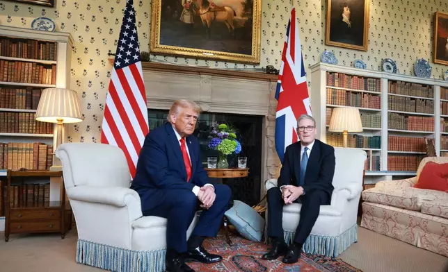 President Donald Trump, left, is greeted by Britain's Prime Minister Keir Starmer as he visits the prime minister's country residence Chequers, near Aylesbury, England, Thursday, Sept. 18, 2025. (Ian Vogler/Pool Photo via AP)