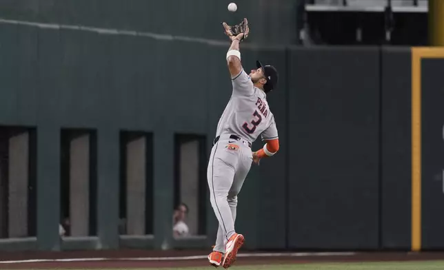 Houston Astros shortstop Jeremy Pena races out to shallow left to catch a fly out by Texas Rangers' Michael Helman in the first inning of a baseball game Friday, Sept. 5, 2025, in Arlington, Texas. (AP Photo/Tony Gutierrez)