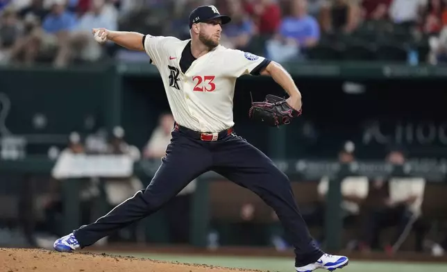 Texas Rangers starting pitcher Merrill Kelly (23) throws to the Houston Astros in the fifth inning of a baseball game Friday, Sept. 5, 2025, in Arlington, Texas. (AP Photo/Tony Gutierrez)