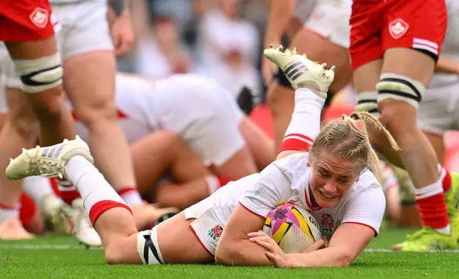 England's Alex Matthews scores a try during the Women's Rugby World Cup final match between England and Canada at the Allianz Stadium, Twickenham in London, Saturday, Sept. 27, 2025.(AP Photo/Anthony Upton)