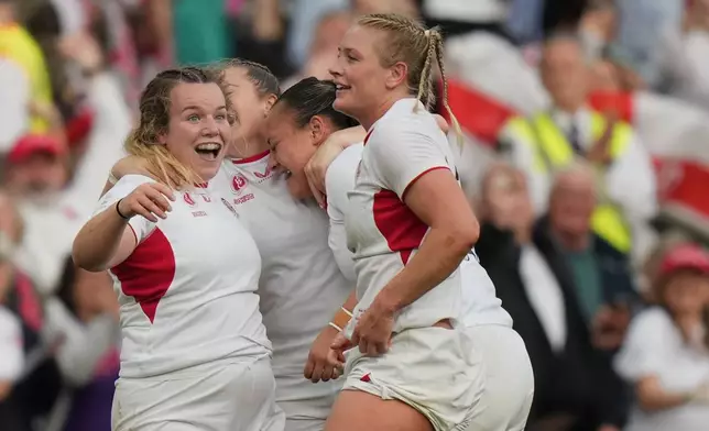 England's players celebrate after winning the Women's Rugby World Cup final match between England and Canada at the Allianz Stadium, Twickenham, London, Saturday, Sept. 27, 2025. (AP Photo/Alastair Grant)