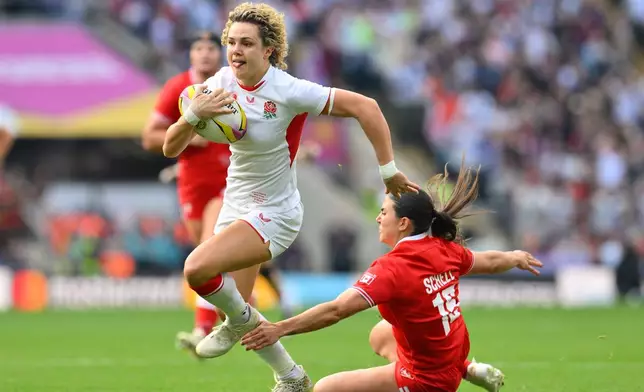England's Ellie Kildunne runs to score a try during the Women's Rugby World Cup final match between England and Canada at the Allianz Stadium, Twickenham in London, Saturday, Sept. 27, 2025.(AP Photo/Anthony Upton)