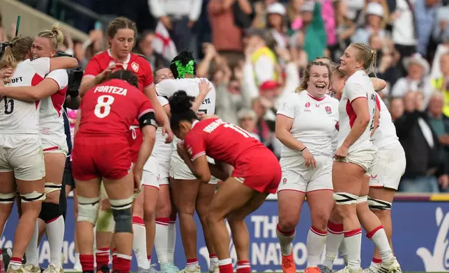 England's players celebrate after winning the Women's Rugby World Cup final match between England and Canada at the Allianz Stadium, Twickenham, London, Saturday, Sept. 27, 2025. (AP Photo/Alastair Grant)