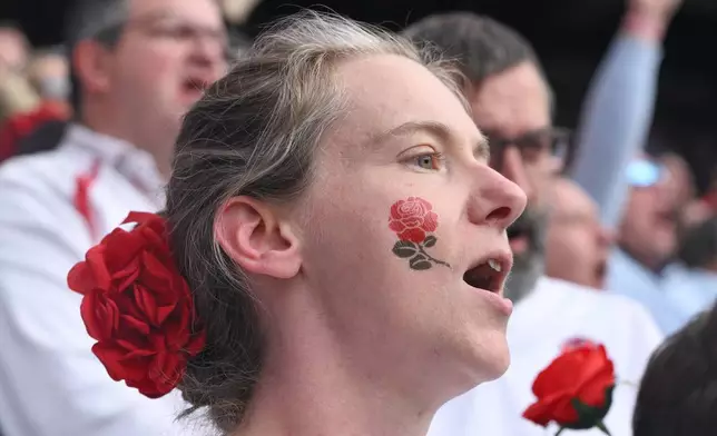 An England supporter cheers during the Women's Rugby World Cup final match between England and Canada at the Allianz Stadium, Twickenham in London, Saturday, Sept. 27, 2025.(AP Photo/Anthony Upton)
