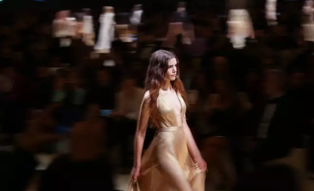 A model wears a creation as part of the Roberto Cavalli Spring/Summer 2026 collection presented in, in Milan, Thursday, Sept. 25, 2025. (AP Photo/Antonio Calanni)