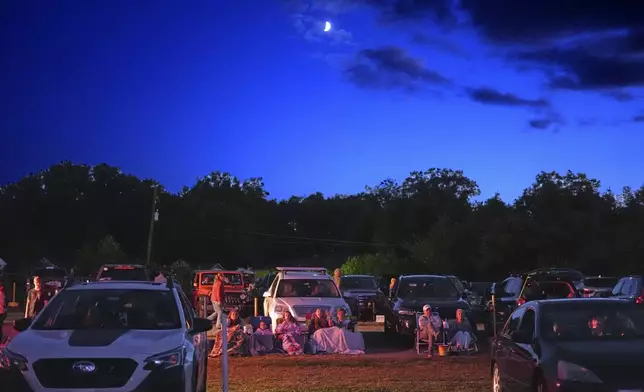 The Gambrill family, center, of Brookhaven, Pa., watch "Jaws" bundled up in front of their car at the Shankweiler Drive-In in Orefield, Pa., Friday, Aug. 29, 2025. (AP Photo/Gene J. Puskar)