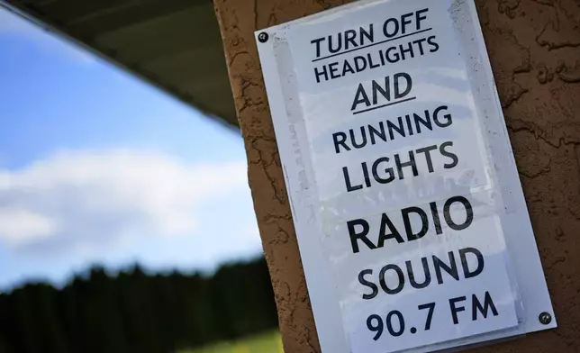 A reminder to turn off head lights at the entrance to Shankweiler Drive-In in Orefield, Pa., Friday, Aug. 29, 2025. (AP Photo/Gene J. Puskar)