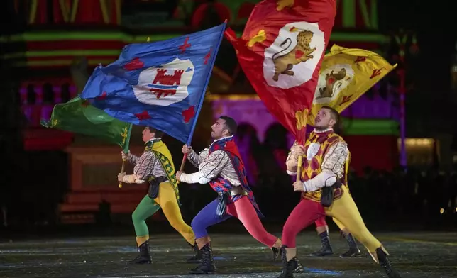 Members of the historic Flag-wavers of the Contrade of Cori, Italy perform during the closing ceremony of the Spasskaya Tower International Military Music Festival in Red Square in front of the St. Basil Cathedral in Moscow, Russia, on Sunday, Aug. 31, 2025. (AP Photo/Alexander Zemlianichenko)