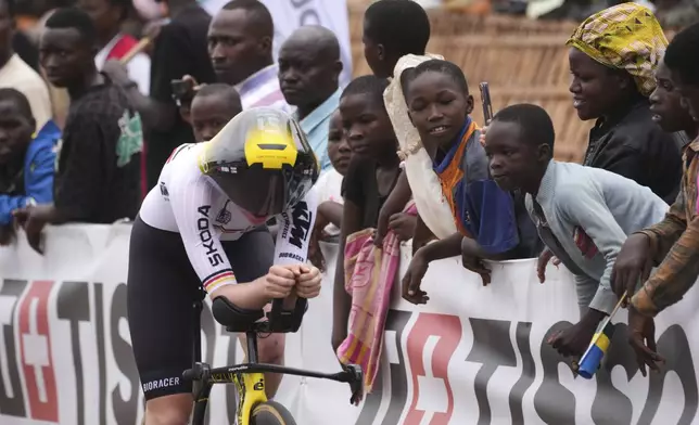 Germany's Linda Riedmann rides past spectators as she competes in the women's Under 23 individual time trial event, at the road cycling World Championships in Kigali, Rwanda, Monday, Sept. 22, 2025. (AP Photo/Jerome Delay)
