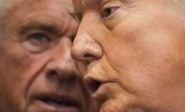 Health and Human Services Secretary Robert F. Kennedy Jr., listens as President Donald Trump speaks in the Roosevelt Room of the White House, Monday, Sept. 22, 2025, in Washington. (AP Photo/Mark Schiefelbein)