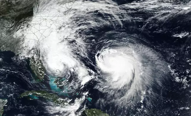 This Monday, Sept. 29, 2025, satellite image released by NASA shows Tropical Storm Imelda, left, and Hurricane Humberto in the Atlantic Ocean. (NASA Worldview, Earth Observing System Data and Information System (EOSDIS) via AP)