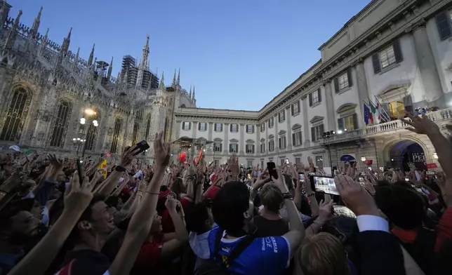 Ferrari fans cheer Ferrari driver Lewis Hamilton of Britain and his teammate Charles Leclerc of Monaco, on the occasion of a sponsor event in front of the Duomo gothic cathedral, in Milan, Italy , Wednesday, Sept. 3, 2025. The Formula one race will be held on Sunday. (AP Photo/Luca Bruno)