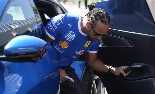 Ferrari driver Lewis Hamilton of Britain arrives at the Monza racetrack, in Monza, Italy, Thursday, Sept. 4, 2025. (AP Photo/Luca Bruno)