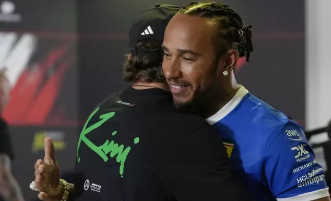Mercedes driver Andrea Kimi Antonelli of Italy, left, hugs Britain's Lewis Hamilton at the Monza racetrack, in Monza, Italy, Thursday, Sept. 4, 2025. (AP Photo/Luca Bruno)