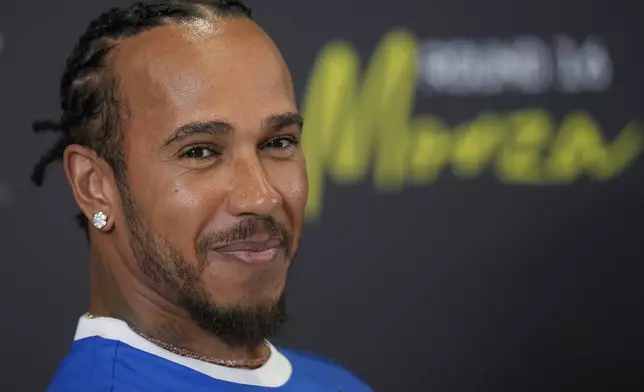 Ferrari driver Lewis Hamilton of Britain smiles during a news conference at the Monza racetrack, in Monza, Italy, Thursday, Sept. 4, 2025. (AP Photo/Luca Bruno)
