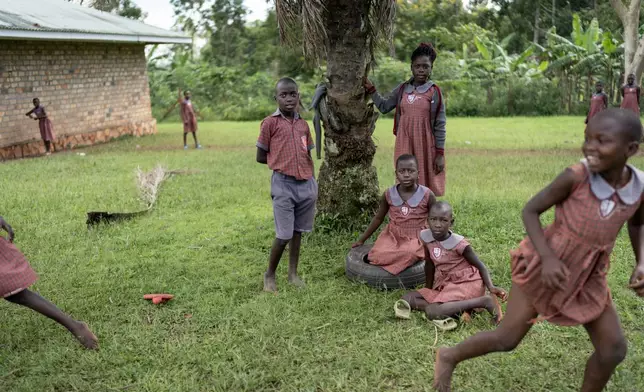 Students play at a special school for children being raised by their grandparents run by the NGO Reach One Touch One Ministries to help support seniors in the community, in Magogo, Uganda, Saturday, Nov. 16, 2024. (AP Photo/David Goldman)