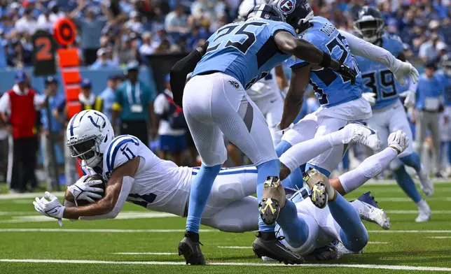 Indianapolis Colts wide receiver Michael Pittman (11) dives into the end zone for a touchdown against the Tennessee Titans during the second half of an NFL football game Sunday, Sept. 21, 2025, in Nashville, Tenn. (AP Photo/John Amis)