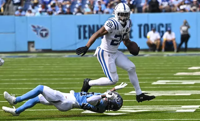 Indianapolis Colts running back Jonathan Taylor (28) breaks away from Tennessee Titans cornerback L'Jarius Sneed (38) during the second half of an NFL football game Sunday, Sept. 21, 2025, in Nashville, Tenn. (AP Photo/John Amis)
