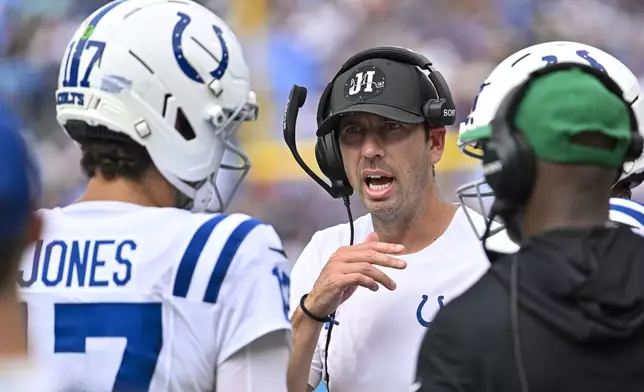 Indianapolis Colts head coach Shane Steichen talks with quarterback Daniel Jones (17) during the first half of an NFL football game against the Tennessee Titans Sunday, Sept. 21, 2025, in Nashville, Tenn. (AP Photo/John Amis)