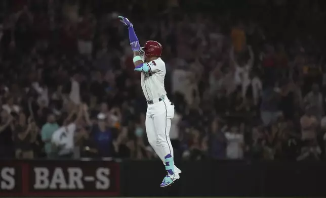 Arizona Diamondbacks' Ketel Marte celebrates his three-run home run against the Texas Rangers during the seventh inning of a baseball game Tuesday, Sept. 2, 2025, in Phoenix. (AP Photo/Ross D. Franklin)