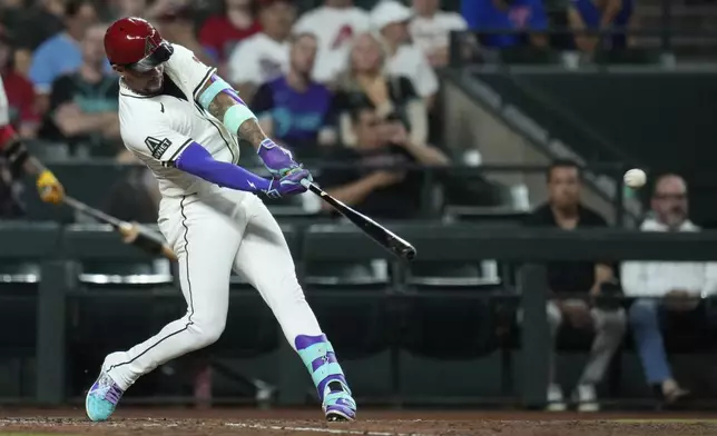 Arizona Diamondbacks' Ketel Marte connects for a three-run home run against the Texas Rangers during the seventh inning of a baseball game Tuesday, Sept. 2, 2025, in Phoenix. (AP Photo/Ross D. Franklin)