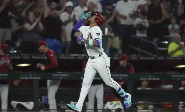 Arizona Diamondbacks' Ketel Marte rounds the bases after hitting a three-run home run against the Texas Rangers during the seventh inning of a baseball game Tuesday, Sept. 2, 2025, in Phoenix. (AP Photo/Ross D. Franklin)