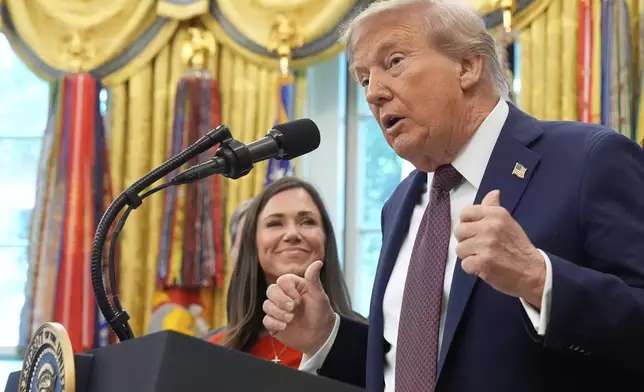President Donald Trump speaks during an event about the relocation of U.S. Space Command headquarters from Colorado to Alabama in the Oval Office of the White House, Tuesday, Sept. 2, 2025, in Washington, as Sen. Katie Britt, R-Ala., listens. (AP Photo/Mark Schiefelbein)