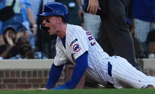 Chicago Cubs' Pete Crow-Armstrong reacts after scoring on a two-run double by Dansby Swanson during the sixth inning of a baseball game against the Atlanta Braves in Chicago, Monday, Sept. 1, 2025. (AP Photo/Nam Y. Huh)