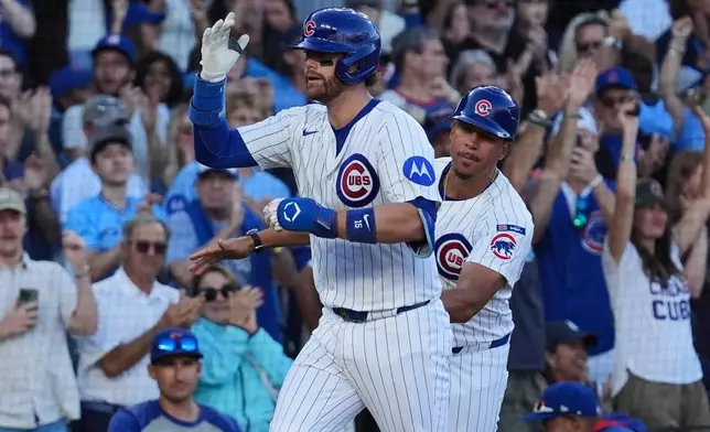 Chicago Cubs' Carson Kelly, left, is congratulated by third base coach Quintin Berry, right, after hitting a two-run home run during the eighth inning of a baseball game against the Atlanta Braves in Chicago, Monday, Sept. 1, 2025. (AP Photo/Nam Y. Huh)