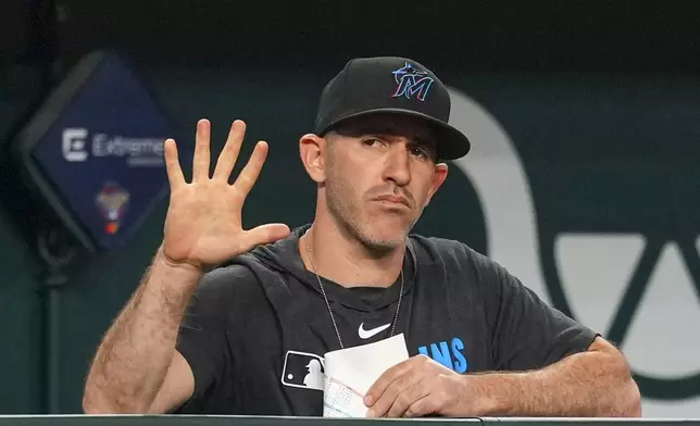 Miami Marlins assistant pitching coach &amp; assistant pitching director Alon Leichman gestures signs toward catcher Agustín Ramírez during the eighth inning of a baseball game Saturday, Sept. 20, 2025, in Arlington, Texas. (AP Photo/Julio Cortez)