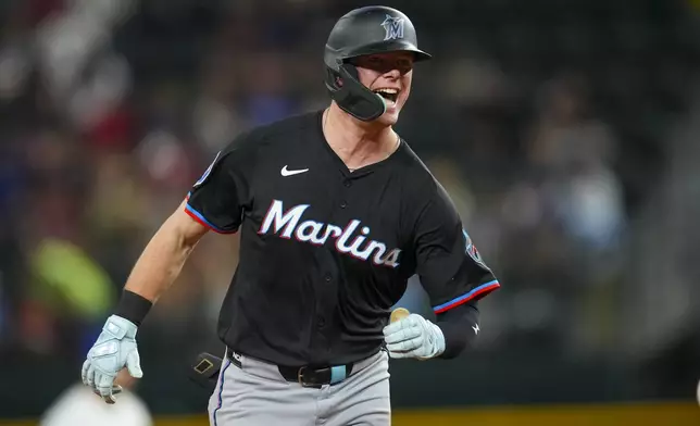 Miami Marlins' Troy Johnston reacts after hitting a solo home run against the Texas Rangers during the sixth inning of a baseball game Saturday, Sept. 20, 2025, in Arlington, Texas. (AP Photo/Julio Cortez)