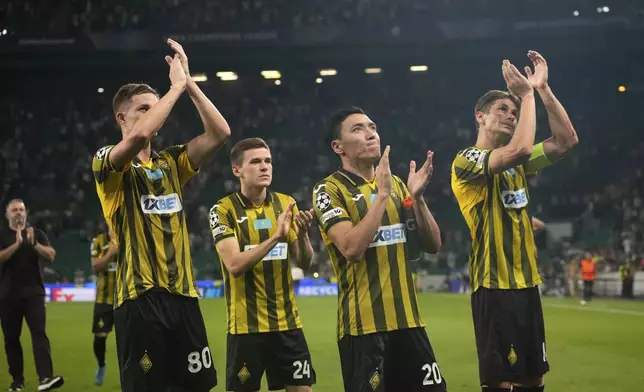 Kairat players applaud their supporters at the end of the Champions League opening phase soccer match between Sporting CP and Kairat Almaty at the Alvalade stadium in Lisbon, Thursday, Sept. 18, 2025. (AP Photo/Ana Brigida)