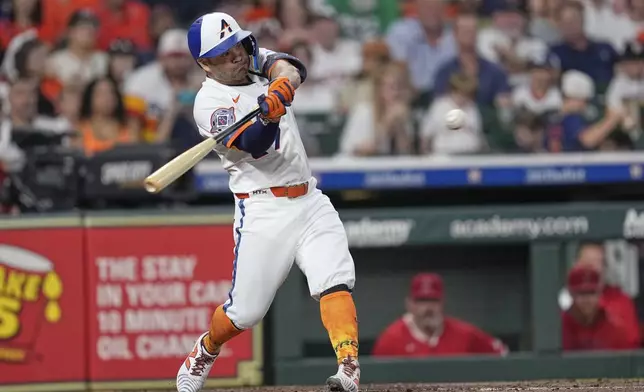 Houston Astros' Jose Altuve hits a RBI double against the Los Angeles Angels during the third inning of a baseball game Monday, Sept. 1, 2025, in Houston. (AP Photo/David J. Phillip)