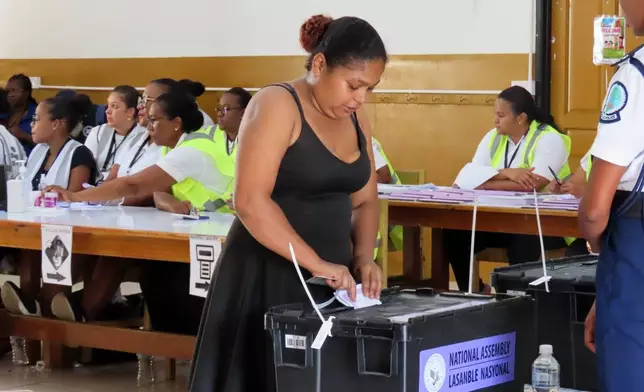 A woman casts her vote at English River School in Victoria, Seychelles, Thursday, Sept. 25, 2025. (AP Photo/Emilie Chetty)