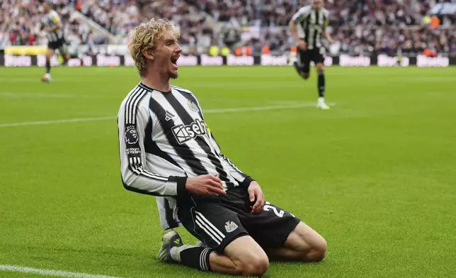Newcastle United's Nick Woltemade celebrates scoring their side's first goal of the game during the Premier League match between Newcastle and Wolverhampton at St James' Park, Newcastle upon Tyne, England, Saturday Sept. 13, 2025. (Owen Humphreys/PA via AP)