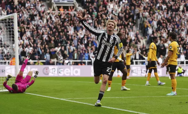 Newcastle United's Nick Woltemade celebrates scoring their side's first goal of the game during the Premier League match between Newcastle and Wolverhampton at St James' Park, Newcastle upon Tyne, England, Saturday Sept. 13, 2025. (Owen Humphreys/PA via AP)