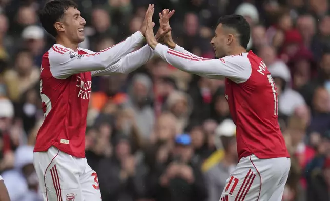 Arsenal's Martín Zubimendi, left, and Gabriel Martinelli celebrate after a goal during the Premier League soccer match between Arsenal and Nottingham Forest in London, Saturday, Sept. 13, 2025. (AP Photo/Kin Cheung)