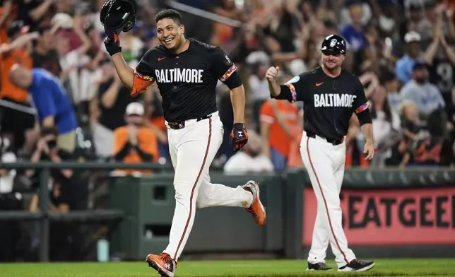 Baltimore Orioles' Samuel Basallo, left, celebrates after hitting a walkoff home run during the ninth inning of a baseball game against the Los Angeles Dodgers, Friday, Sept. 5, 2025, in Baltimore. (AP Photo/Stephanie Scarbrough)