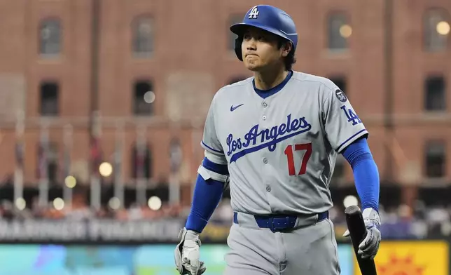 Los Angeles Dodgers' Shohei Ohtani reacts after striking out swinging during the first inning of a baseball game against the Baltimore Orioles, Friday, Sept. 5, 2025, in Baltimore. (AP Photo/Stephanie Scarbrough)