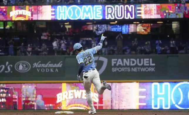 Milwaukee Brewers' Christian Yelich hits a two-run home run during the seventh inning of a baseball game against the St. Louis Cardinals Friday, Sept. 12, 2025, in Milwaukee. (AP Photo/Morry Gash)