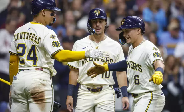 Milwaukee Brewers' Isaac Collins(10) reacts with William Contreras (24) after his three-run home run during the first inning of a baseball game against the Philadelphia Phillies, Wednesday, Sept. 3, 2025, in Milwaukee. (AP Photo/Jeffrey Phelps)