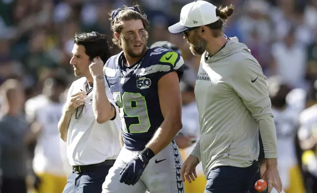 Seattle Seahawks' Jake Bobo leaves the field after an injury during the first half of a preseason NFL football game against the Green Bay Packers Saturday, Aug. 23, 2025, in Green Bay, Wis. (AP Photo/Matt Ludtke)