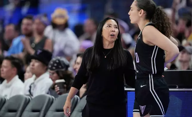 Golden State Valkyries head coach Natalie Nakase, left, speaks to guard Carla Leite, right, during the second half of a WNBA basketball game against the Indiana Fever, Sunday, Aug. 31, 2025, in San Francisco. (AP Photo/Godofredo A. Vásquez)
