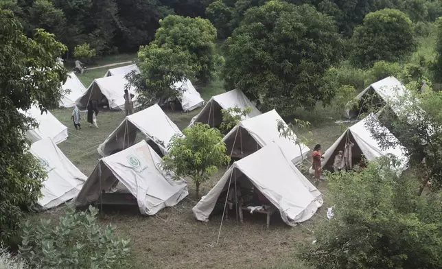 People, who fled from their homes due to flood, take shelter at a relief camp on the outskirts of Multan, Pakistan, Tuesday, Sept. 2, 2025. (AP Photo/Asim Tanveer)