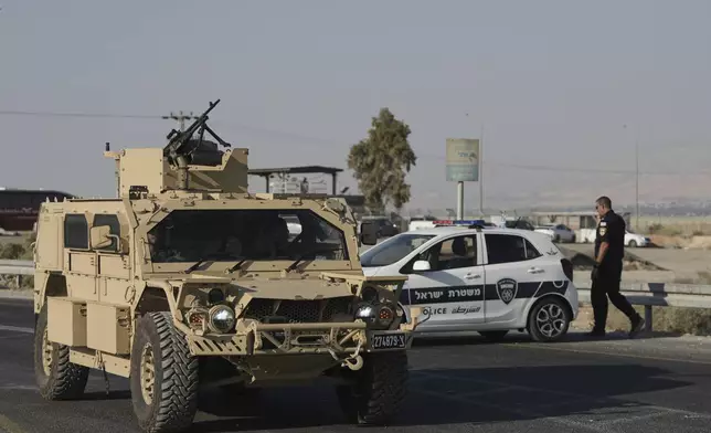 Israeli police and soldiers stand guard near the site of a shooting attack where Israeli officials say two people were shot and killed in a militant attack at the Allenby Bridge Crossing between the West Bank and Jordan, Thursday, Sept. 18, 2025. (AP Photo/Mahmoud Illean)