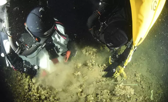 In this undated photo provided by the Greek Culture Ministry on Monday, Sept. 15, 2025, divers carefully sift to recover objects from the wreck site of the Britannic, sister ship to the Titanic, for the first time since the ocean liner sank in the Aegean Sea more than a century ago after striking a mine during World War I. (Greek Culture Ministry via AP)