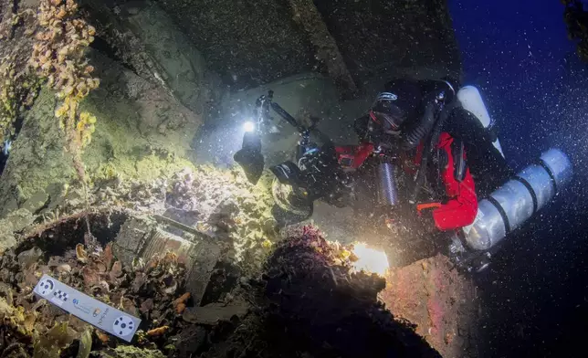 In this undated photo provided by the Greek Culture Ministry on Monday, Sept. 15, 2025, divers illuminate the wreck's interior of the Britannic, sister ship to the Titanic, for the first time since the ocean liner sank in the Aegean Sea more than a century ago after striking a mine during World War I. (Greek Culture Ministry via AP)